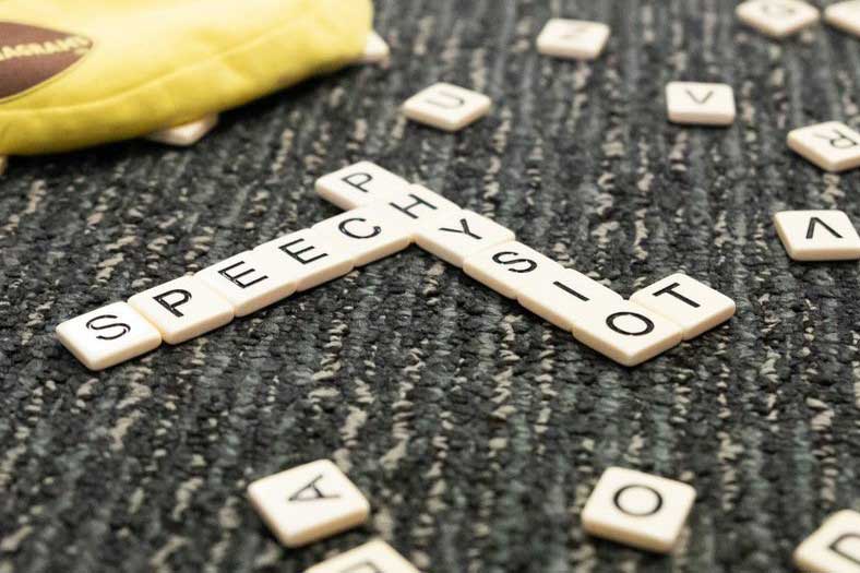 Scrabble tiles spelling speech physio and OT